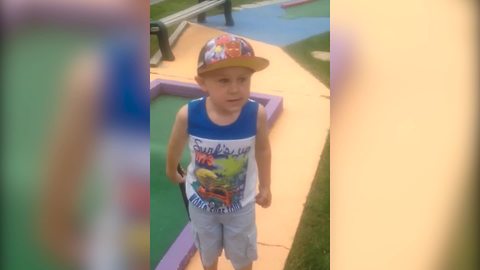 Little Boy Cheats In Mini Golf Game