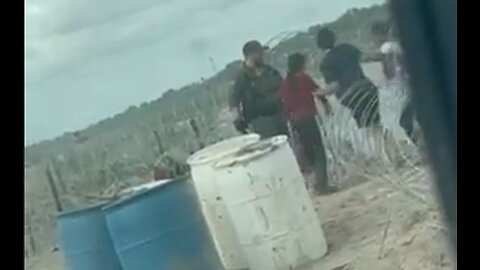 Federal border patrol agent cuts razor wire & holds it as invaders go through on private property