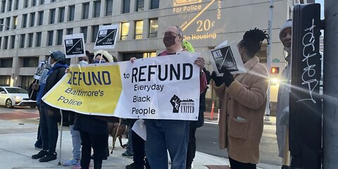 Group rallies in downtown Baltimore to call on city to reduce police budget and invest more communities