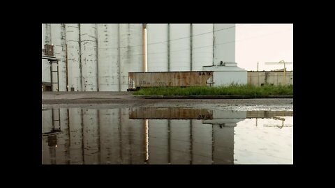 Rain on a puddle near a grain elevator at General Mills Inc in Minneapolis, Minnesota