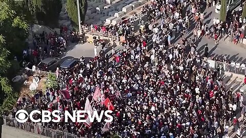 Mass protests in Israel, migrant boat capsizes in English Channel, more | CBS News 24/7