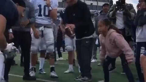 Little girl shows University Of Nevada football players how it's done