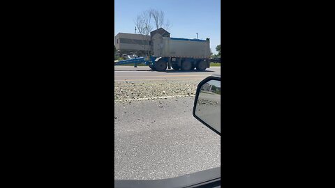 Dump Truck Drops Gravel On Highway