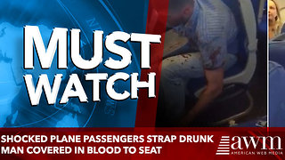 Shocked plane passengers strap drunk man covered in blood to seat