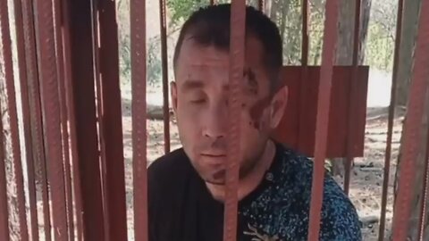 A Russian soldier was put in a cage for refusing to take part in a "meat assault" on Ukrainian positions.