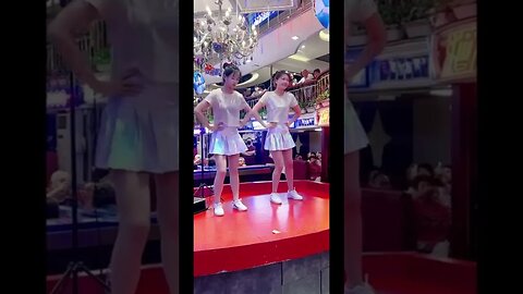 Two Cute Chinese Girls Dance In The Mall For Shoppers