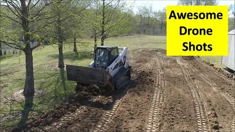 Bobcat T650 rough grading Illinois homestead lawn with skid steer 4 in 1 bucket CTL