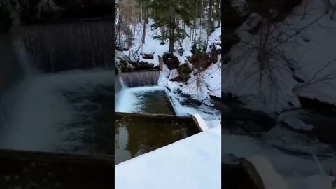 Snow by a waterfall in canada