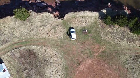 Drone flying straight up near Lighthouse