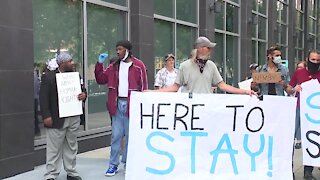 Homeless men staying at hotel gather outside county HQ