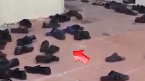 A shoe goes out of control in a shoe storage area in a mosque when no one is supposed to be there