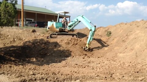 Yanmar Excavator Cleaning a Pond