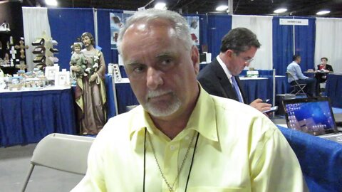 Author Roger Leblanc on the Holy Mass Crucifix at the catholic marketing Trade Show