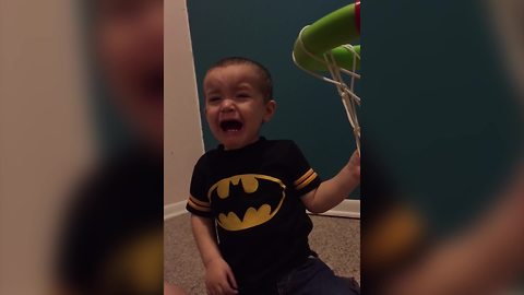 A Tot Boy Cries After Making A Shot On A Toy Hoop