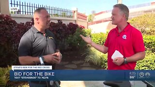 Steve Weagle thanks Spiro Georgedakis for donating bike back to Red Cross