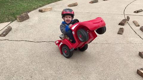 Tot Boy Tips A Toy Car Back And Rides In Circles