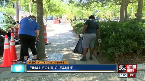 Volunteers clean along Rverwalk in preparation for the NCAA Women's Final Four Championship