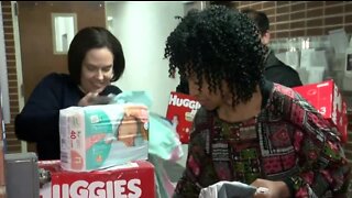 Local corporation collects items for Community Baby Shower