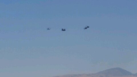 Helicopters Fly in Formation over desert