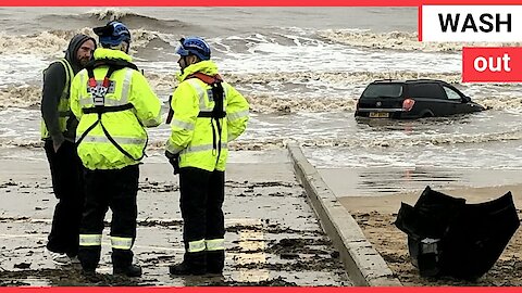 Footage shows a car submerged in high tide after it became stuck on a beach