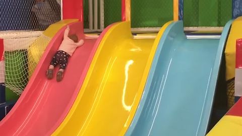 Baby Girl Slides Down Into A Ball Pool