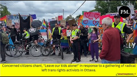 Concerned citizens chant, "Leave our kids alone!" in response to a gathering of radical