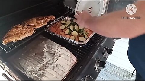 Outdoor cooking veggies and chicken on the grill