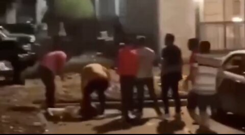 Illegal Venezuelan migrants beat a man unconscious while gunfire erupts in the distance