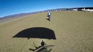 Skydiver makes awesome landing on moving motorcycle!