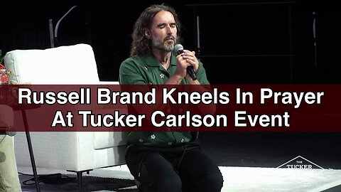 Russell Brand Kneels In Prayer at Tucker Carlson Event