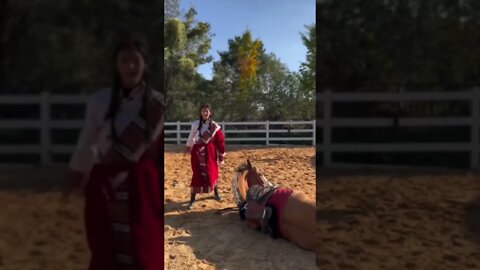 Minority Chinese Girl In The Countryside Lays Her Horse Down