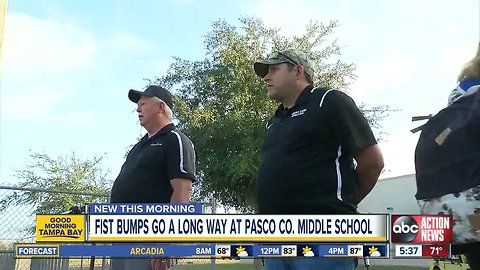 Two Pasco Co. school employees help kids get their day started on a positive note with a fist bump