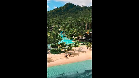 beautifull beach srounded by blue watervand greenry