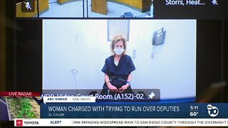 Woman charged with trying to run over deputies pleads not guilty