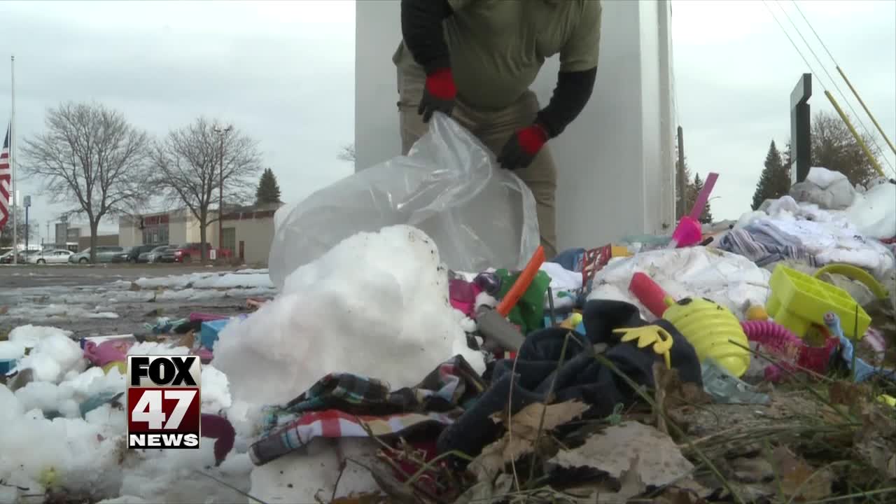 Trash surrounds donation bins in South Lansing