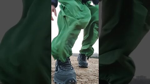 Green parachute pants flapping