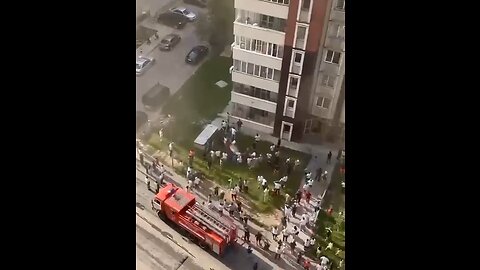 Crazy footage from Kazakhstan where children are jumping out of a high rise building on fire