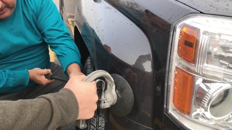 Father and son pulling out the fender dent on my GMC Terrain