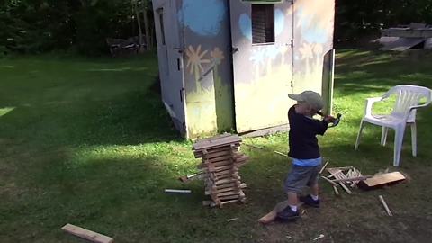 Tot Boy Knocks A Pile Of Sticks Down