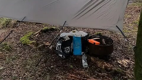 Portable firepit under a tarp . pid campsite. Dartmoor. 23rd March 2023