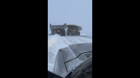 Haul trucks in Alaska helping each other out ￼