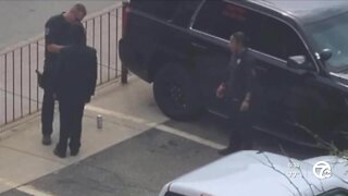 Police officer photographed help boy tie his tie