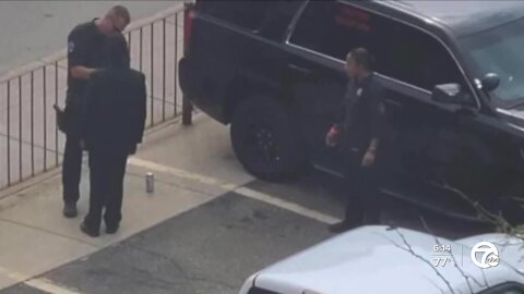 Police officer photographed help boy tie his tie