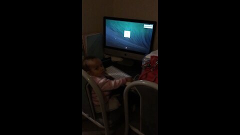 Baby learning to type on computer