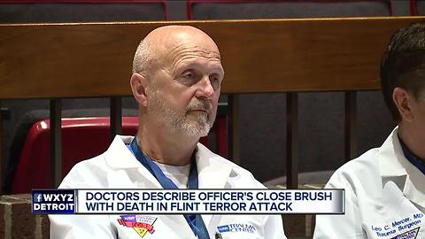 Doctor says officer sustained 12-inch wound in Flint airport stabbing