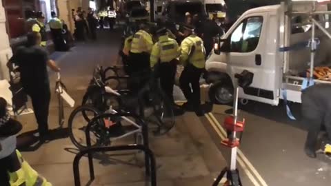 sparks fly as Extinction rebellion protesters chained under a lorry are arrested