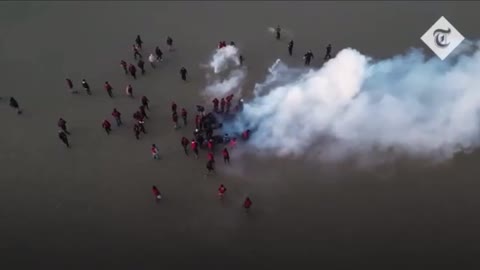 French police tear gassing economic migrants to prevent them crossing The Channel