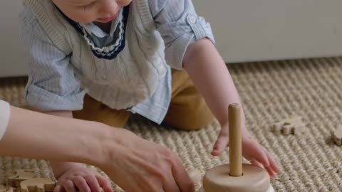 cute little boy playing with mom