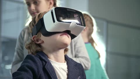 a boy wears a virtual reality headset