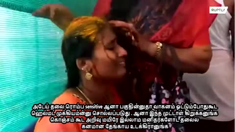 India. Idol Worship. Injured while breaking coconut on head in front of idol